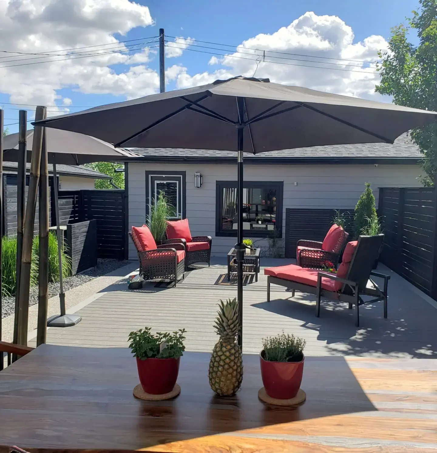 Completed composite deck with outdoor living space by Serenity Construction Calgary