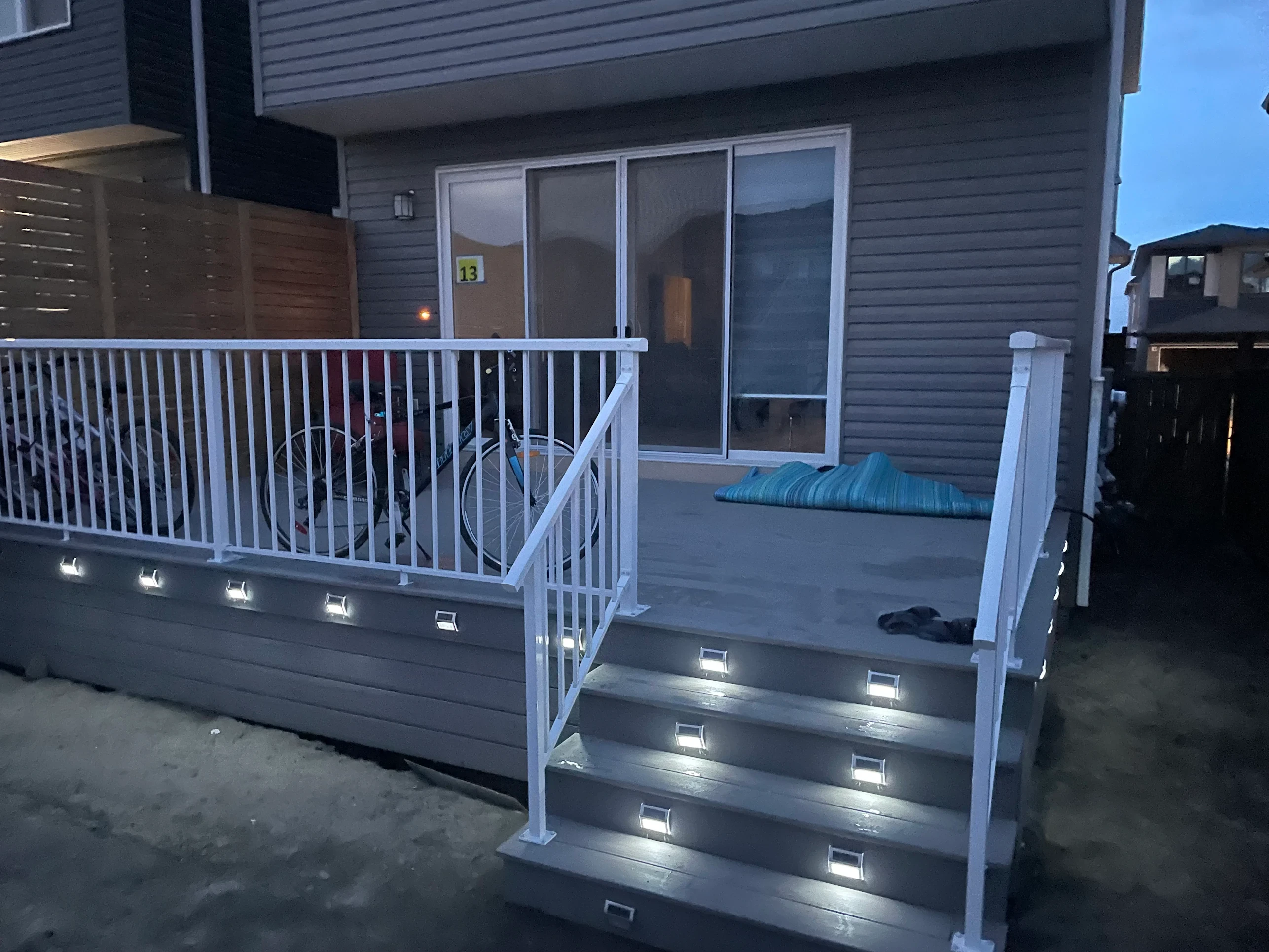 New build composite deck with railing and step lights — Calgary