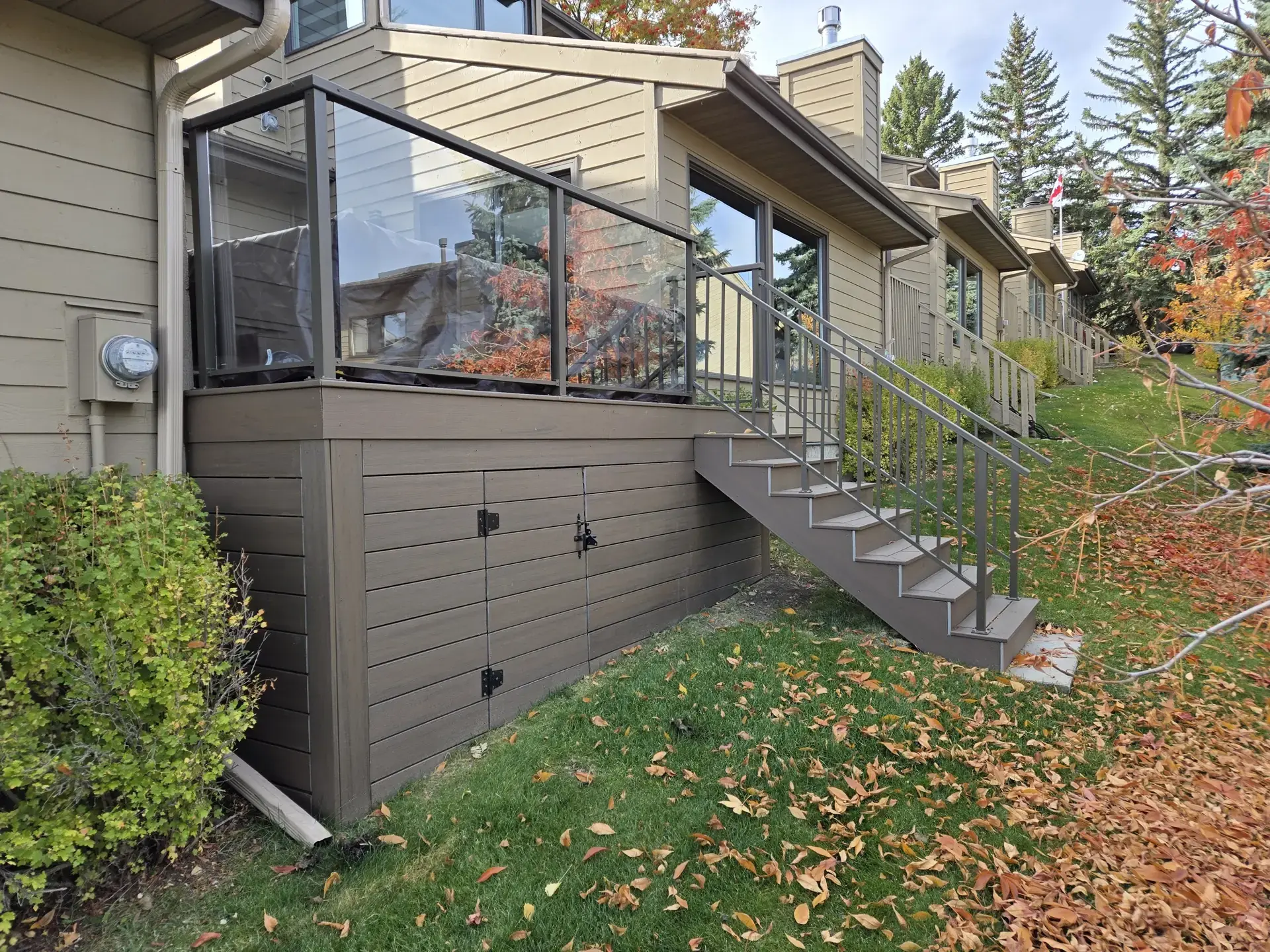 Featured deck with railings and stairs by Serenity Construction