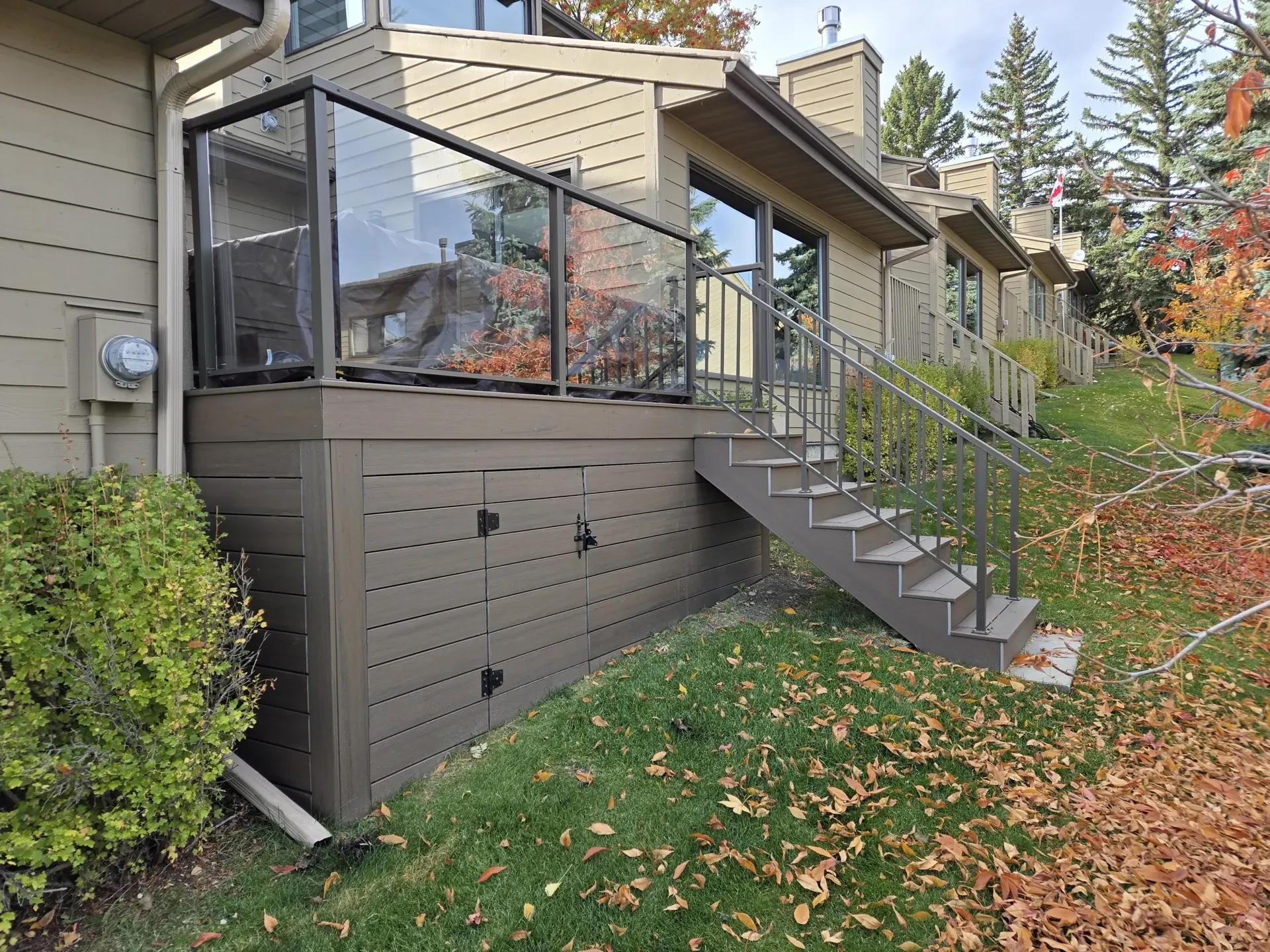Featured deck with railings and stairs by Serenity Construction