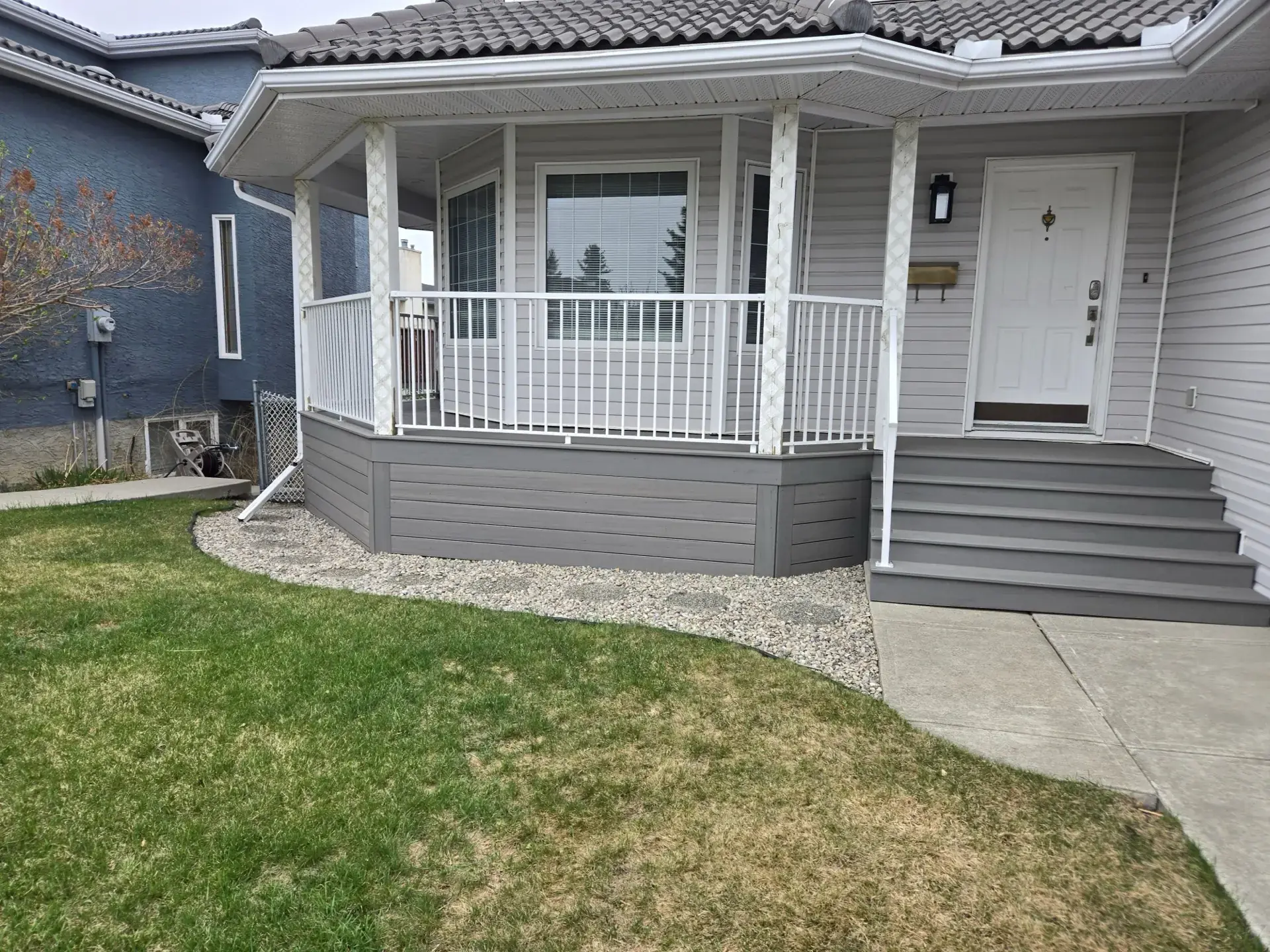 Front porch composite deck with white railing — Calgary