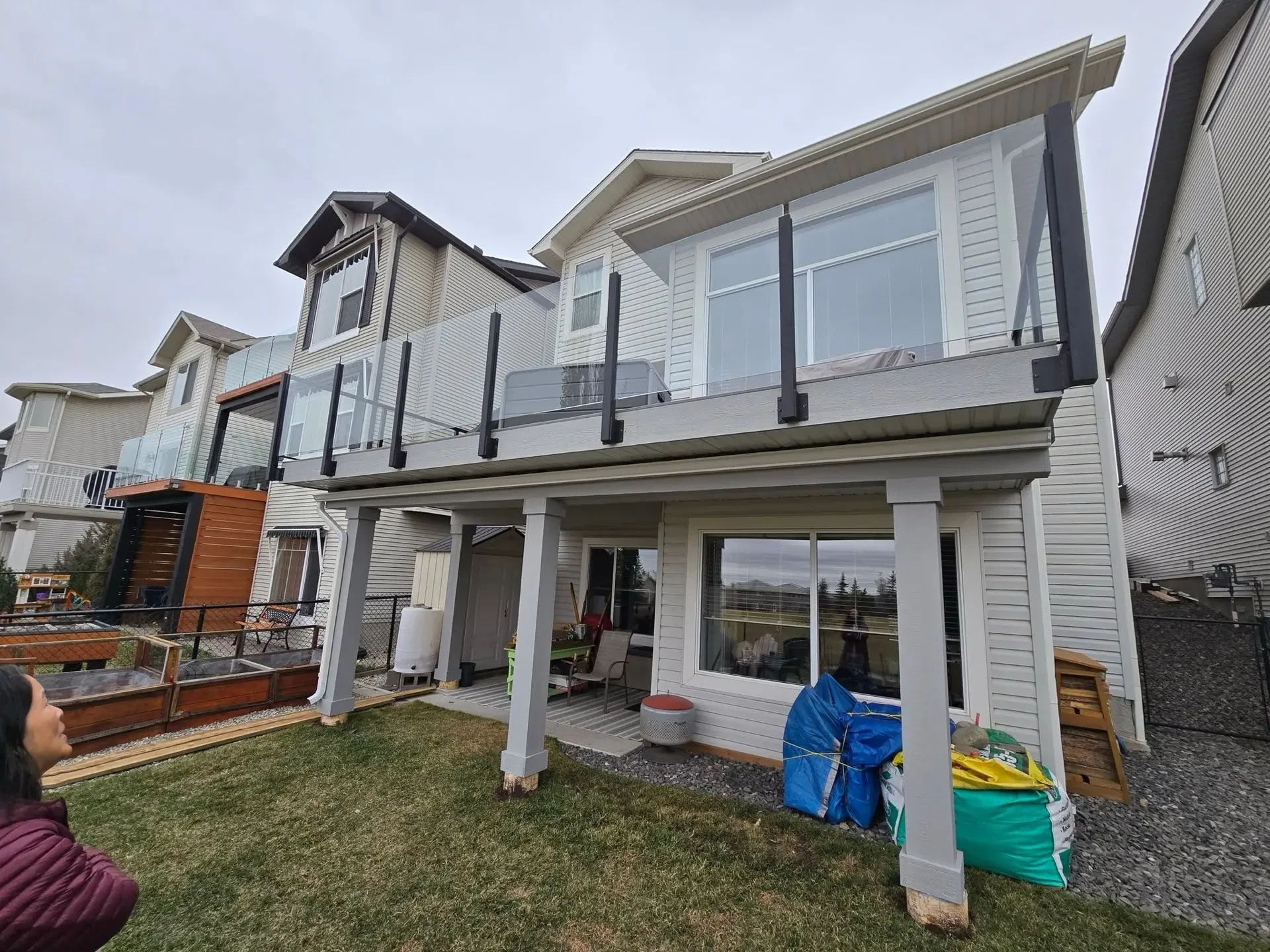 Two-storey deck replacement with glass railing — Calgary