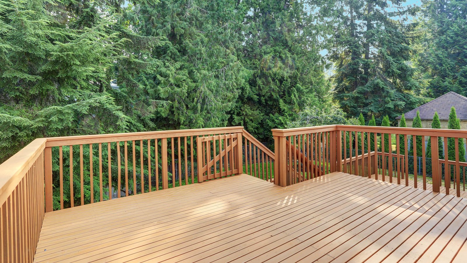 Wooden deck overlooking lush greenery, showcasing deck construction quality and design, relevant for budgeting deck projects.