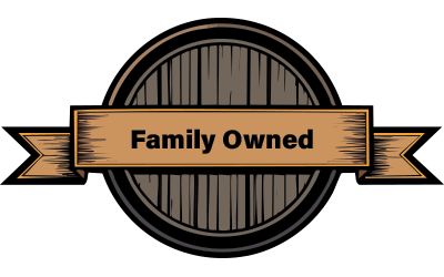Family-owned badge featuring a wooden barrel design with a banner stating "Family Owned," symbolizing trust and community values in deck construction services.